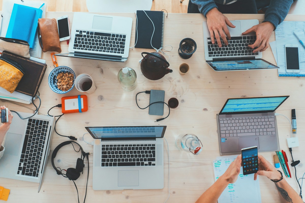 People working together around laptops and notebooks